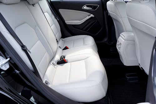 Free Explore the modern and luxurious feel of a car's interior with pristine white leather seats. Stock Photo