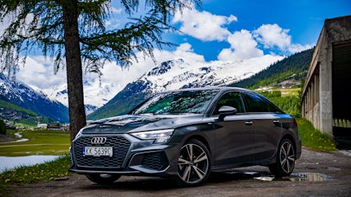 Free The audi a3 sedan parked in front of a mountain Stock Photo