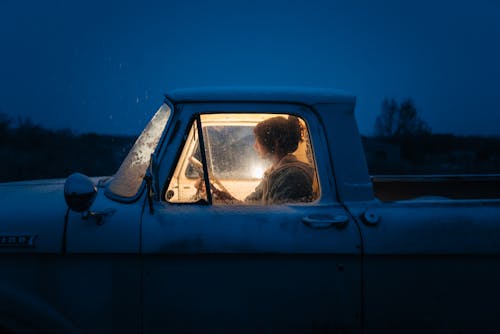 Free Woman Sitting in an Old Pick-up Truck in Winter Stock Photo